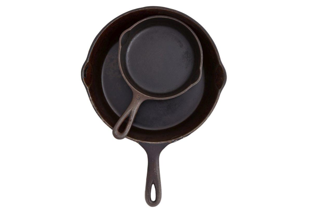 A top view of cast iron pans nested together.