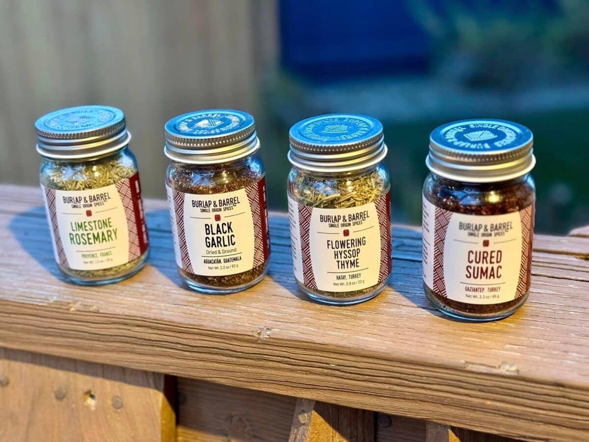4 Burlap & Barrel Spices on a wooden slab