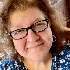 Portrait of Jennifer Heftler with glasses and floral shirt