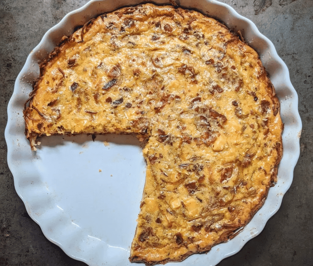 A delicious quiche with smoked gouda, bacon, and caramelized onions.