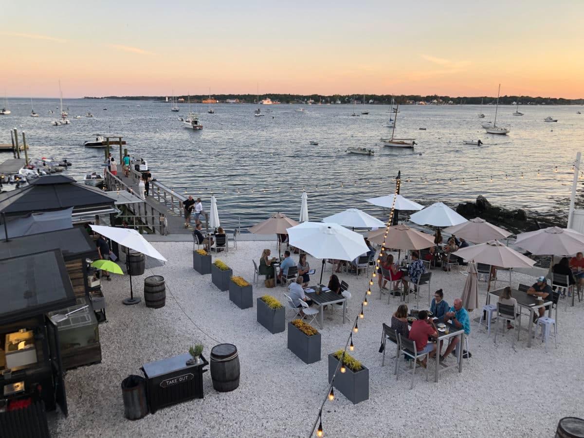 A picturesque sunset view over Pepperrell Cove with boats in the distance.